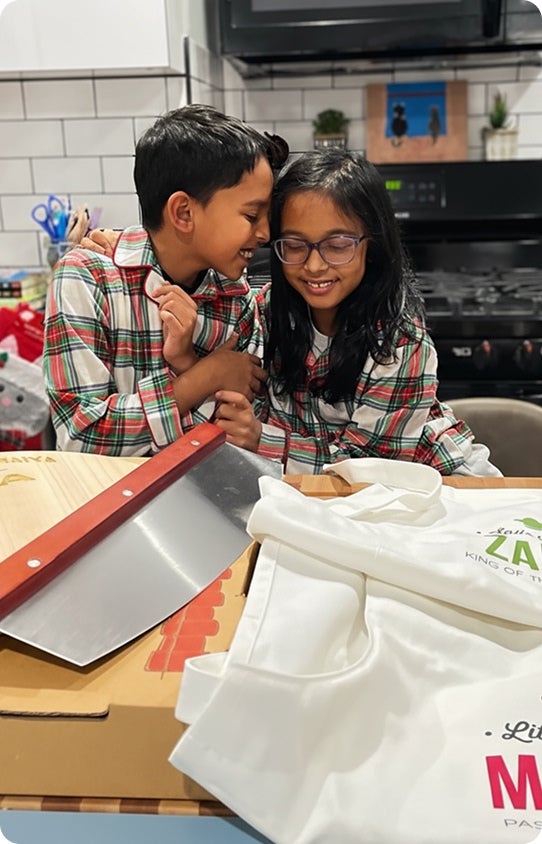 Two children enjoying their personalized Christmas items