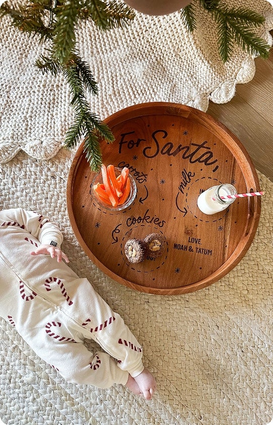 A personalized Christmas tray with names on it holding Santas treats 