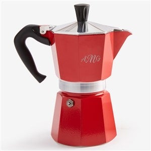 A red coffee pot with the initials AMG on it