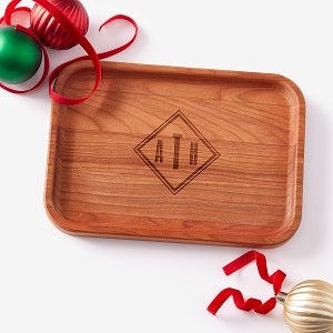Flat wooden dish with the initials ATH on it