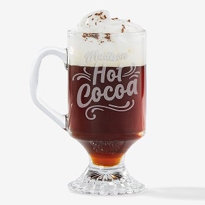 A personalized glass mug with the words, Madison Hot Cocoa, written on it