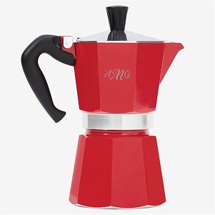 A red coffee pot with the initials AMG on it